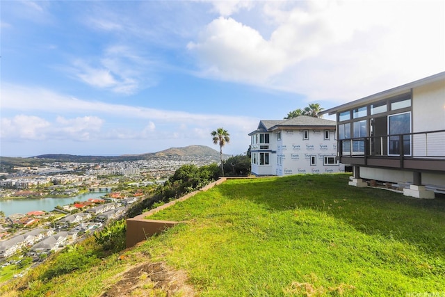 view of yard featuring a water and mountain view