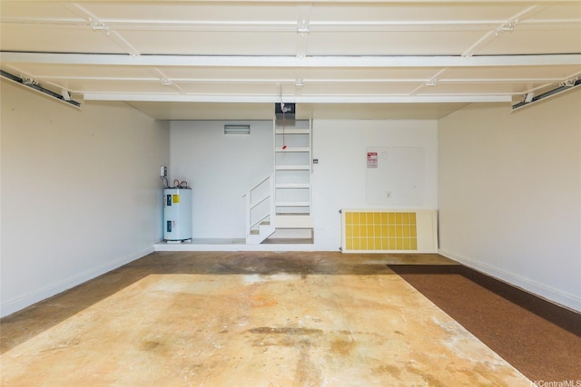 garage with a garage door opener, water heater, visible vents, and baseboards