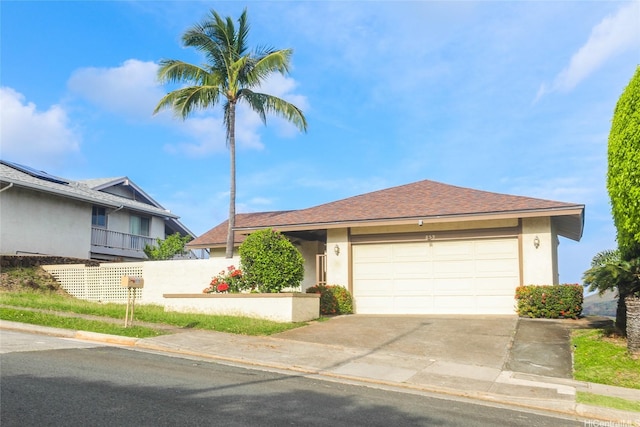 single story home with stucco siding, concrete driveway, a shingled roof, and a garage