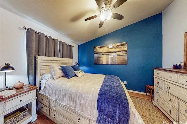 bedroom with lofted ceiling, ceiling fan, and wood finished floors