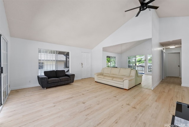 living room featuring high vaulted ceiling, ceiling fan, baseboards, and wood finished floors