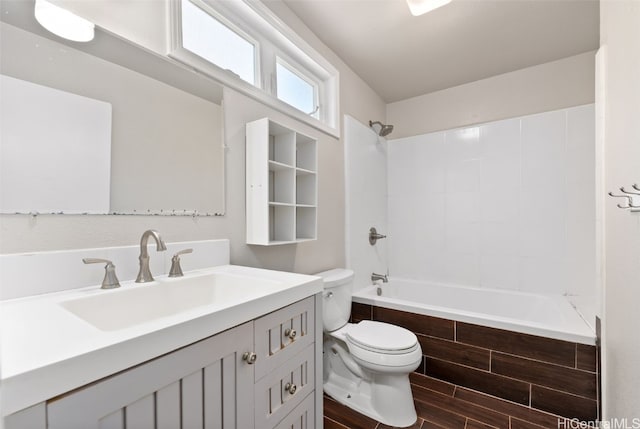 bathroom with toilet, bathtub / shower combination, wood finish floors, and vanity