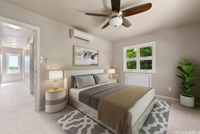 bedroom with a ceiling fan, baseboards, an AC wall unit, and light colored carpet