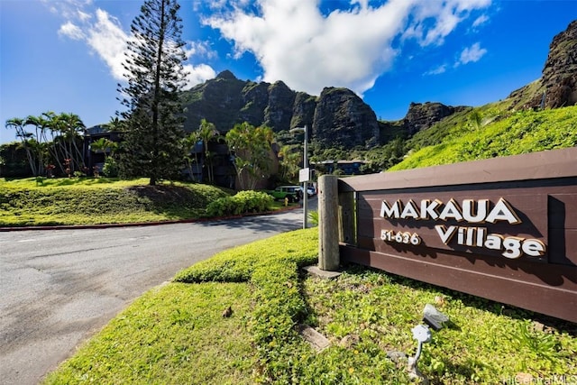 community sign with a mountain view