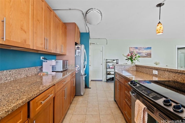 kitchen featuring light tile patterned flooring, stainless steel appliances, light stone countertops, brown cabinetry, and decorative light fixtures