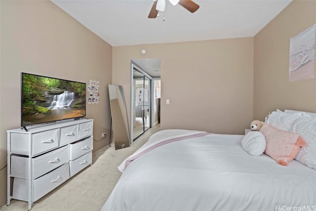 bedroom with a ceiling fan and light colored carpet