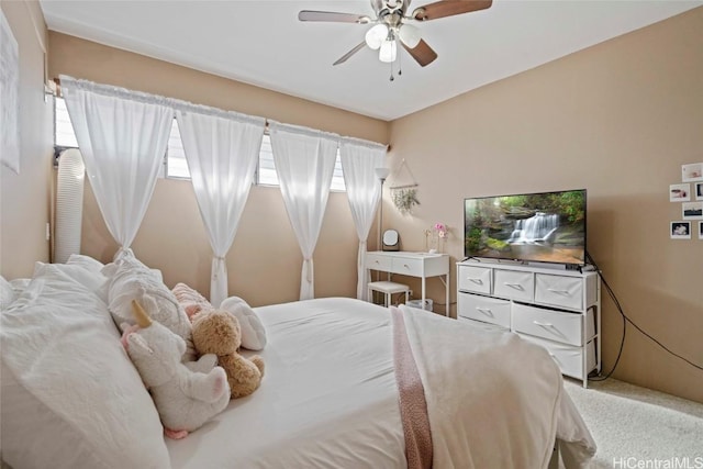 bedroom featuring light carpet and a ceiling fan