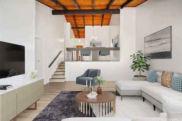 living area with beamed ceiling, stairway, light wood-style floors, wooden ceiling, and a chandelier