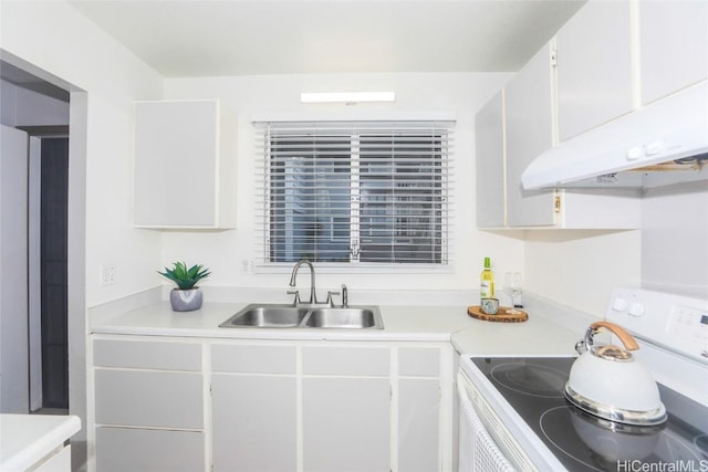 kitchen featuring under cabinet range hood, a sink, white cabinetry, light countertops, and white range with electric stovetop