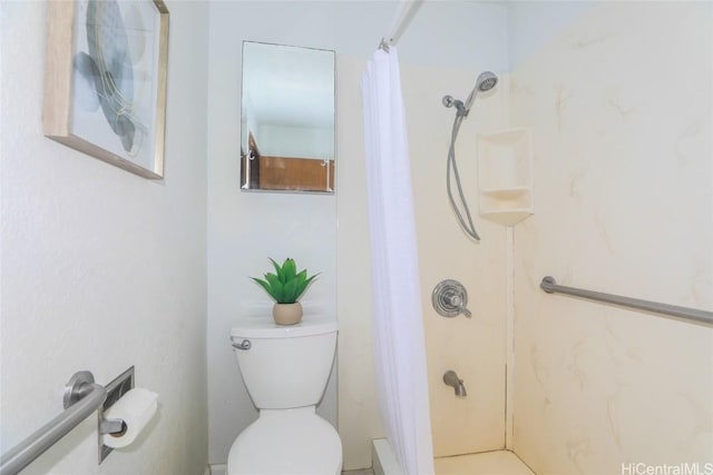 full bathroom with toilet and a shower stall