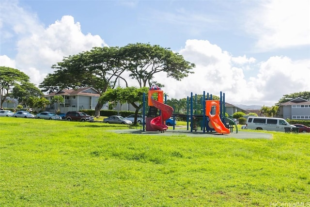 community jungle gym with a lawn