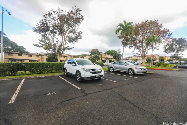 uncovered parking lot with a residential view