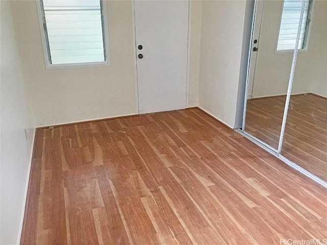 spare room featuring wood finished floors