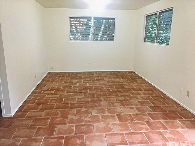 spare room featuring baseboards