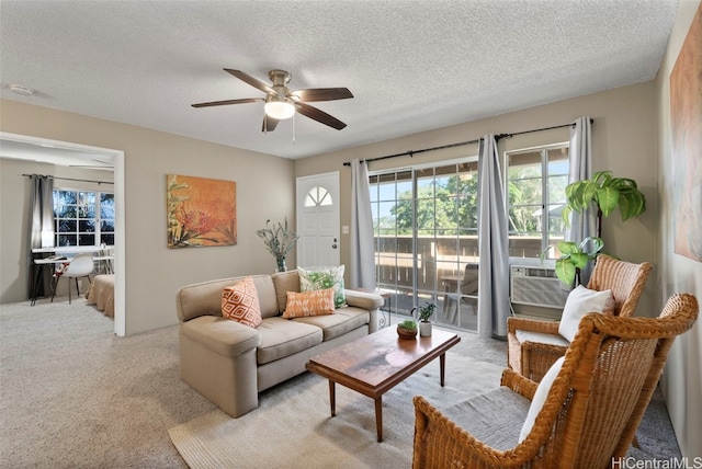 living room featuring light carpet, a textured ceiling, a ceiling fan, and cooling unit