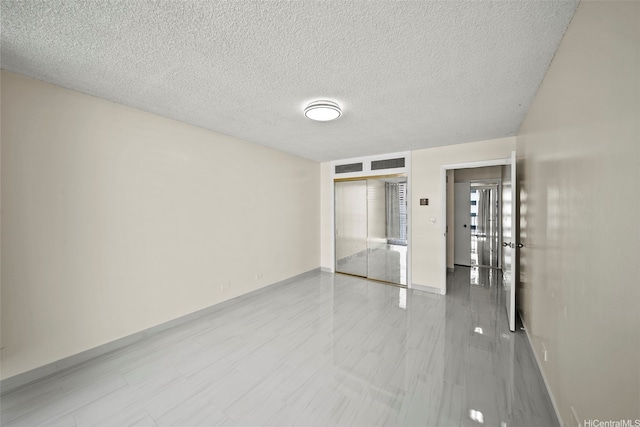1561 Kanunu St Unit 801, Honolulu, HI 96814 - spare room featuring baseboards and a textured ceiling