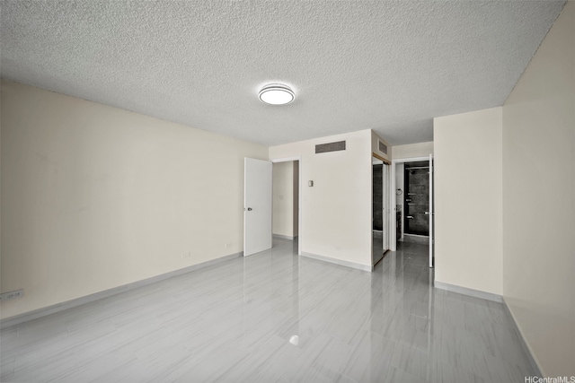 unfurnished bedroom featuring baseboards, visible vents, a textured ceiling, and a closet
