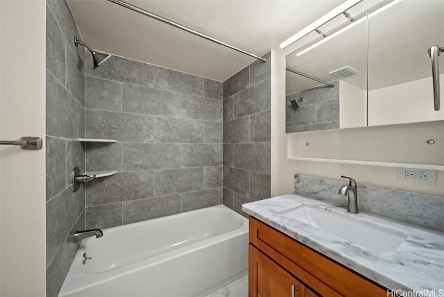 bathroom featuring vanity, bathtub / shower combination, and visible vents