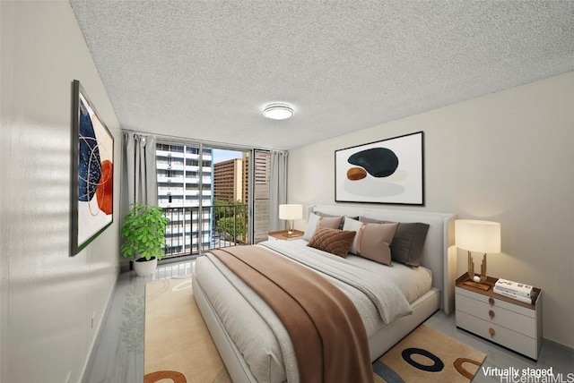 bedroom with floor to ceiling windows and a textured ceiling