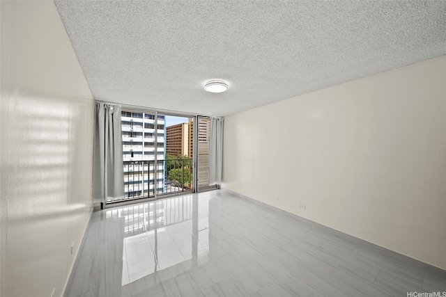 1561 Kanunu St Unit 801, Honolulu, HI 96814 - empty room featuring a wall of windows and a textured ceiling