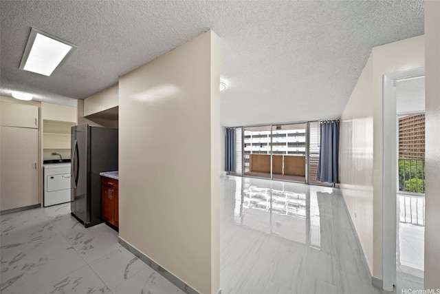 1561 Kanunu St Unit 801, Honolulu, HI 96814 - kitchen with freestanding refrigerator, washer / clothes dryer, baseboards, a textured ceiling, and open floor plan
