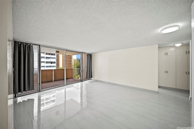 1561 Kanunu St Unit 801, Honolulu, HI 96814 - unfurnished room with a textured ceiling and a wall of windows