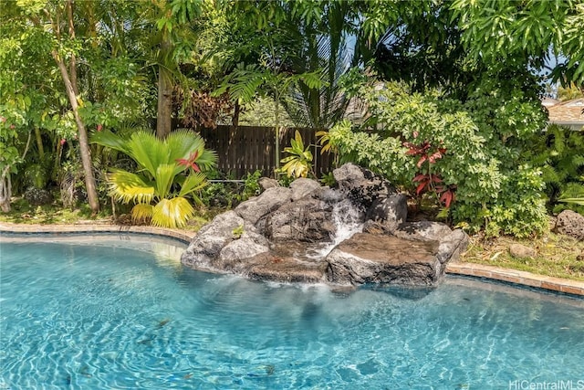 view of pool featuring fence