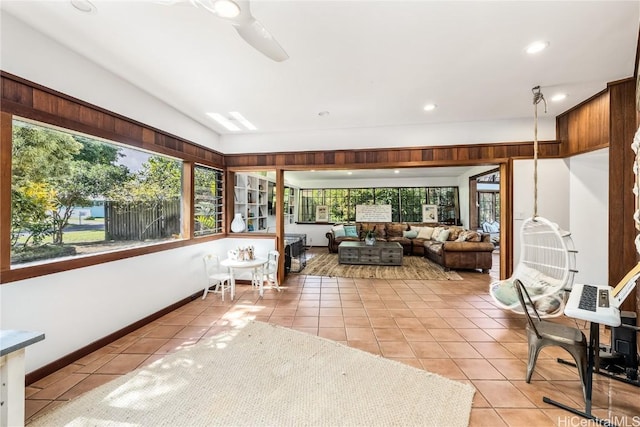 sunroom / solarium featuring a ceiling fan