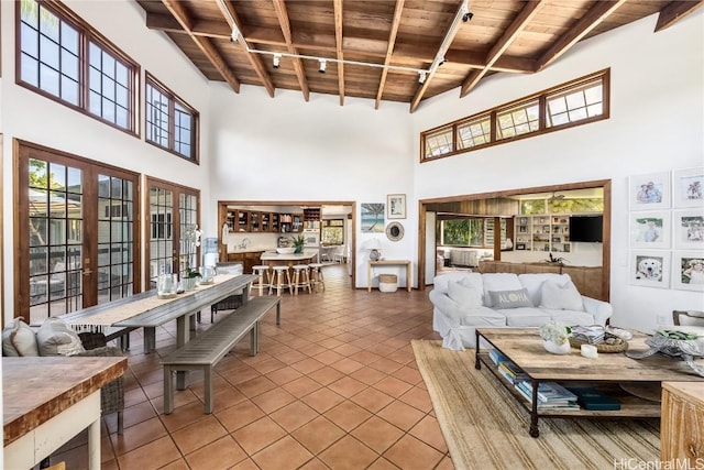 tiled living room with plenty of natural light, wood ceiling, and beamed ceiling