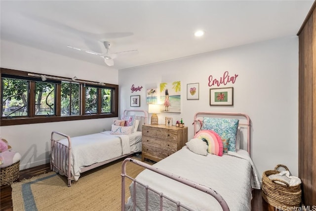 bedroom with a ceiling fan, wood finished floors, and recessed lighting