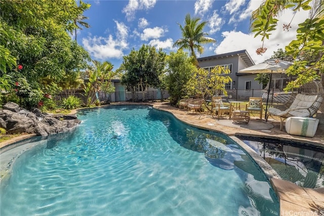 view of swimming pool featuring a patio, fence, and a fenced in pool