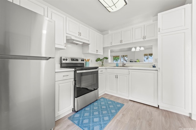 94-634 Lumiaina St Unit F202, Waipahu, HI 96797 - kitchen featuring stainless steel appliances, light countertops, white cabinetry, and light wood-type flooring