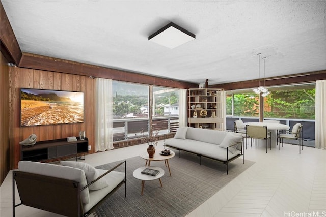 living room with a textured ceiling and wood walls