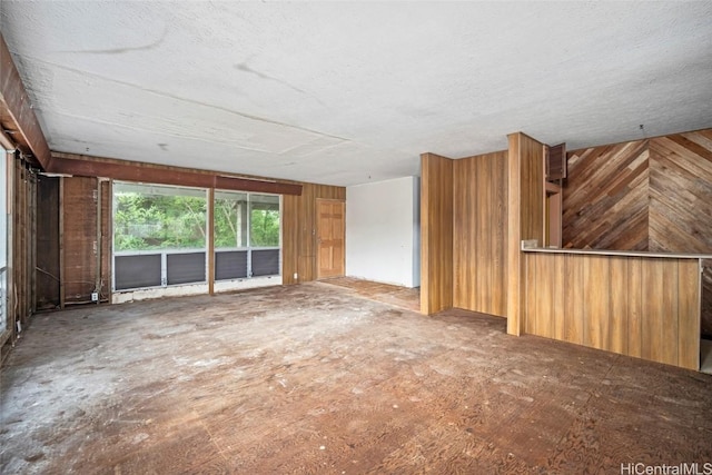 spare room with wood walls