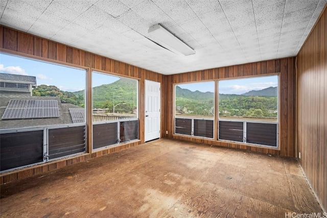 unfurnished sunroom with a mountain view