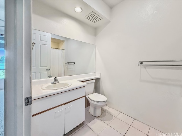 full bathroom featuring toilet, vanity, visible vents, and tile patterned floors