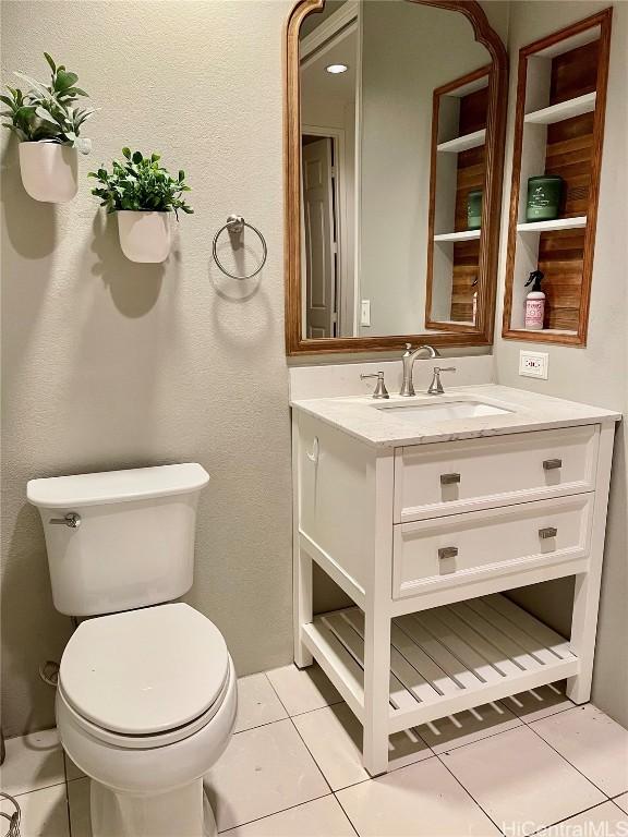 bathroom featuring vanity, toilet, and tile patterned floors