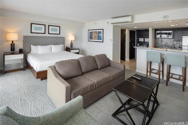 1777 Ala Moana Blvd Unit 2208, Honolulu, HI 96815 - bedroom with a wall unit AC, rail lighting, and stainless steel fridge