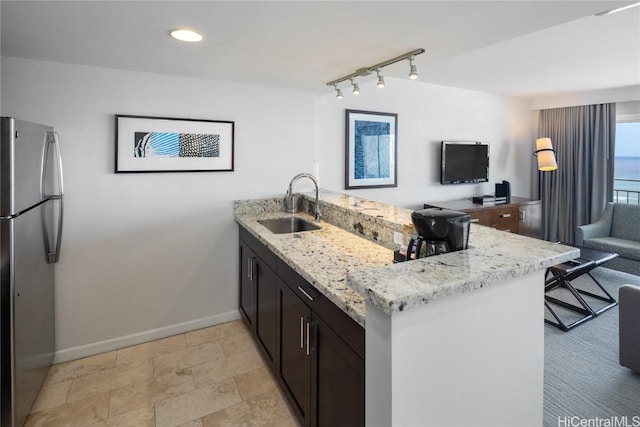 1777 Ala Moana Blvd Unit 2208, Honolulu, HI 96815 - kitchen with open floor plan, freestanding refrigerator, a peninsula, light stone countertops, and a sink