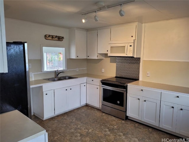 kitchen with stainless steel appliances, light countertops, backsplash, white cabinets, and a sink