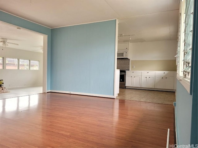 spare room featuring a ceiling fan and light wood-type flooring