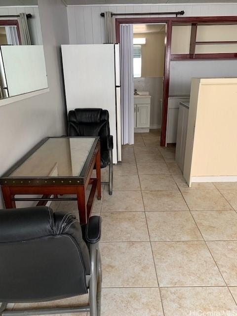 kitchen featuring freestanding refrigerator and light tile patterned flooring