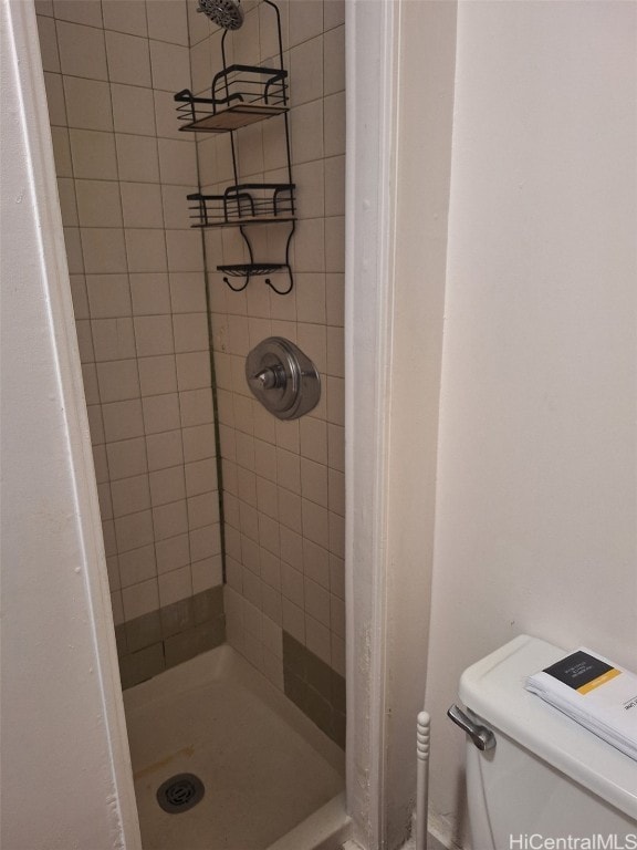 full bathroom with a stall shower and toilet