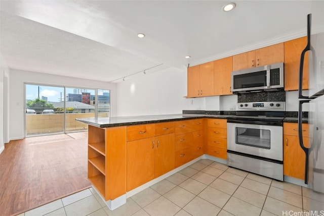 kitchen with open shelves, brown cabinetry, a peninsula, and stainless steel appliances