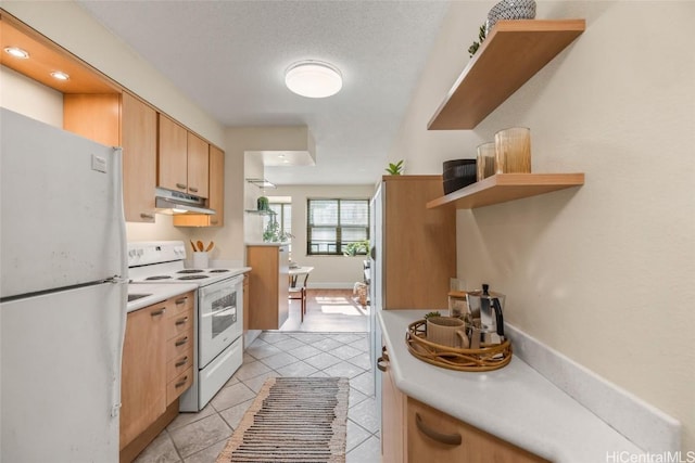 kitchen with refrigerator, white electric range oven, a textured ceiling, and light tile patterned floors