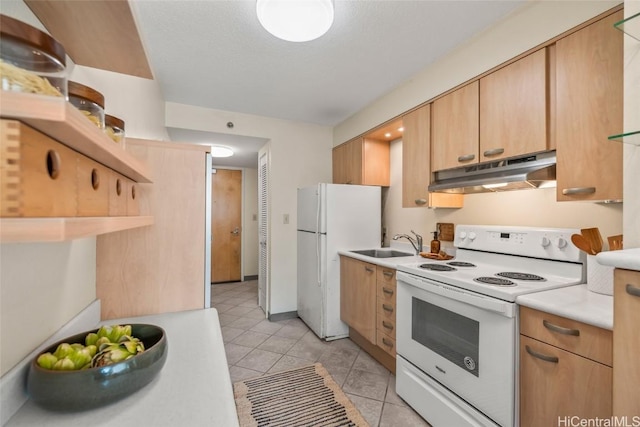 kitchen with white appliances, a textured ceiling, light brown cabinets, light tile patterned floors, and sink