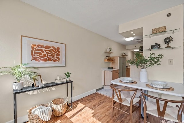 dining space with light hardwood / wood-style flooring