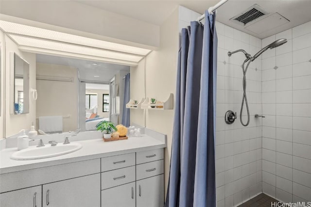 bathroom featuring vanity and curtained shower