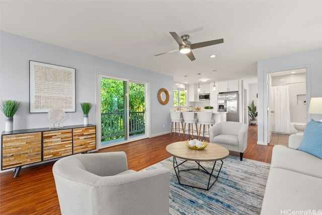 living area featuring ceiling fan, dark wood-type flooring, recessed lighting, and baseboards