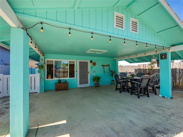 view of patio featuring visible vents and fence